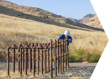 Employee reviewing pipe readings